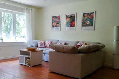 a living room with a couch and a table at Birdsong Bungalow in Port Dover