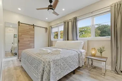 a bedroom with a bed and a window at Redwood Suite in Niagara on the Lake
