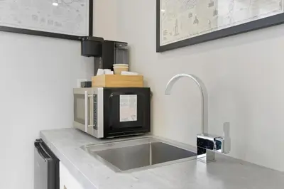 a kitchen counter with a sink and a microwave at Redwood Suite in Niagara on the Lake