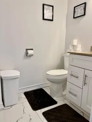 a white bathroom with a toilet and a sink at Private Room Near Airport K8 in Mississauga