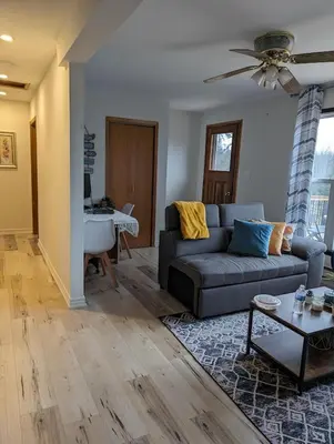 a living room with a couch and a table at Peaceful and Heavenly Private Water Front Cottage on 100 Acres of Scenic Beauty- Trent Lakes in Kinmount
