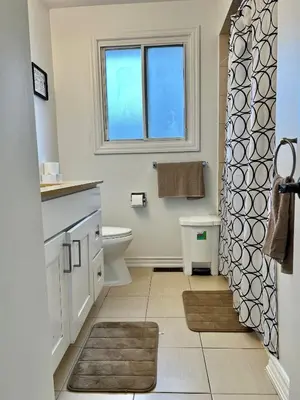 a bathroom with a sink and a toilet and a window at Private Room Near Airport K5 in Mississauga