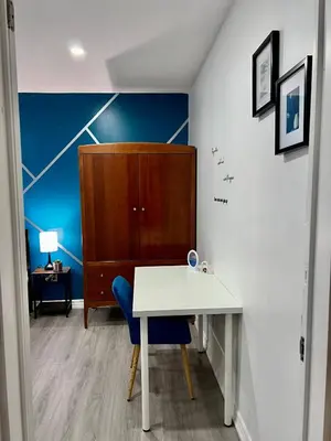 a room with a white table and a blue wall at Private Room Near Airport K4 in Mississauga