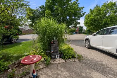 a white car parked next to a garden with a mushroom at Ninos place in Hamilton