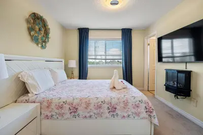 a bedroom with a bed and a tv at Ninos place in Hamilton
