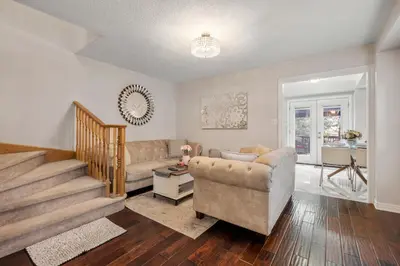 a living room with a couch and a table at Ninos place in Hamilton