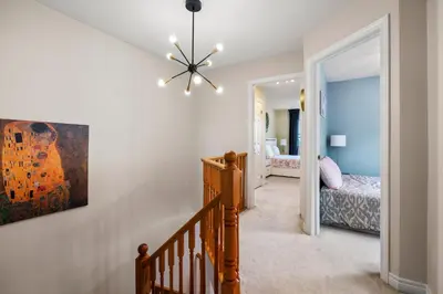 a staircase leading to a bedroom with a bed at Ninos place in Hamilton