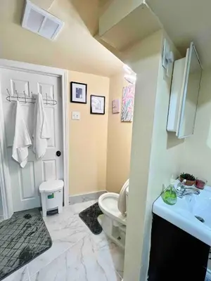a bathroom with a white toilet and a sink at Private Room Near Airport K7 in Mississauga