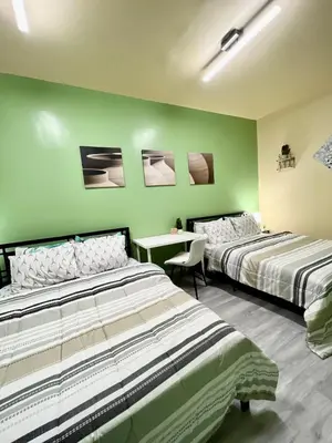two beds in a room with green walls at Private Room Near Airport K6 in Mississauga