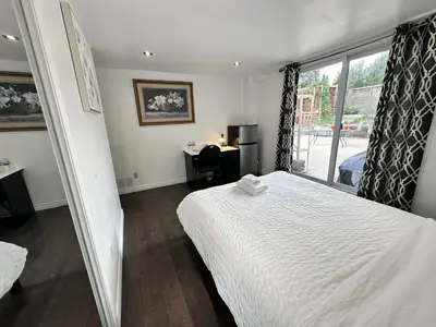 a bedroom with a white bed and a window at Riverwood Home-Entire Rental Unit in Mississauga