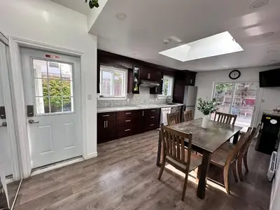 a kitchen and dining room with a table and chairs at Riverwood Home-Entire Rental Unit in Mississauga
