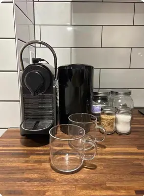 a counter with glasses and a coffee maker on a table at Lower level newly renovated studio apartment in central downtown location in Toronto