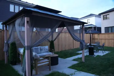 a gazebo with a couch in a backyard at JNShortStay- Niagara Falls Area Hidden Gem in Welland