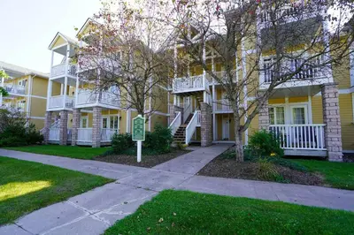 a apartment building with a sidewalk in front of it at Stunning Condo with Access to Pool in Shanty Bay