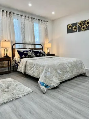 a bedroom with a large bed and two windows at K1 Private Bathroom Queen Bed Room in Mississauga