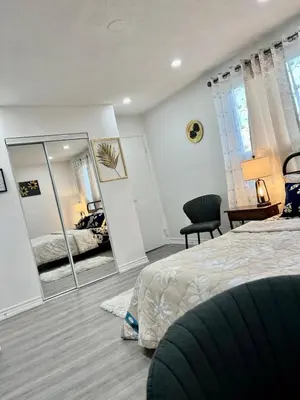a bedroom with a bed and a mirror at K1 Private Bathroom Queen Bed Room in Mississauga