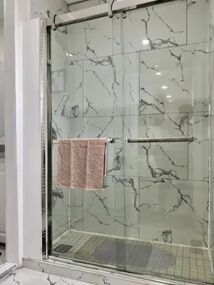 a shower with a glass door with a towel at K1 Private Bathroom Queen Bed Room in Mississauga