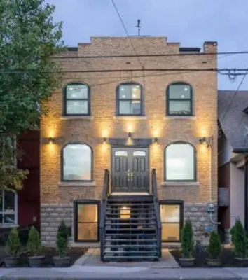 a brick building with a staircase in front of it at Renovated Church Hamilton! Guest Suite in Hamilton