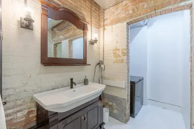 a bathroom with a sink and a mirror at Renovated Church Hamilton! Guest Suite in Hamilton