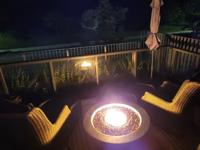 a candle sitting on top of a table with chairs at Nature trail view with cozy patio and firetable in Innisfil