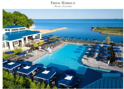a pool at a resort with blue umbrellas and the ocean at Nature trail view with cozy patio and firetable in Innisfil
