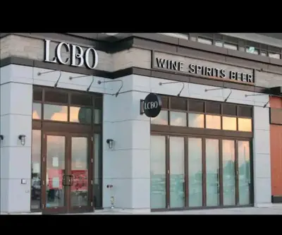 a building with a sign that reads lacoco wine spiritseller at Nature trail view with cozy patio and firetable in Innisfil