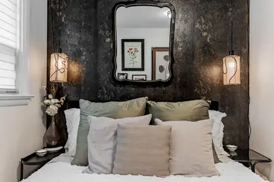 a bedroom with a large mirror above a bed at Unique Oasis with Tri-City Access in Mississauga