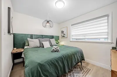 a bedroom with a green bed with a stuffed animal on it at Unique Oasis with Tri-City Access in Mississauga