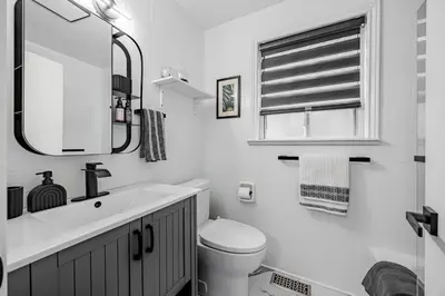 a bathroom with a sink and a toilet and a mirror at Unique Oasis with Tri-City Access in Mississauga
