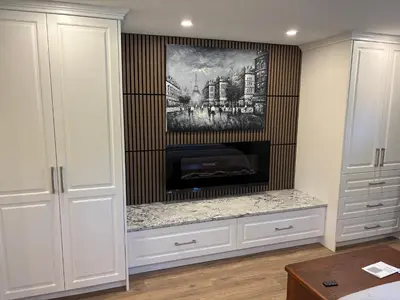a fireplace in a living room with white cabinets at Cozy 1 bedroom basement apartment 14 days minimum in Fonthill