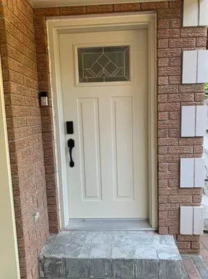 a white door on a brick building with a brick wall at Cozy 1 bedroom basement apartment 14 days minimum in Fonthill