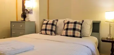 a bedroom with a bed with two pillows at Summit Cottage on Kawagama Lake in Dorset