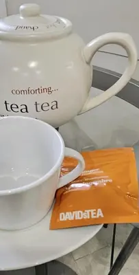 a tea pot and a cup on a table at Serenity Inn in Niagara Falls