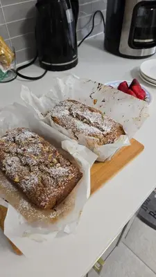 two pieces of bread on a cutting board with strawberries at Serenity Inn in Niagara Falls