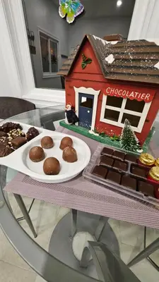 a table with a gingerbread house and a plate of cookies at Serenity Inn in Niagara Falls
