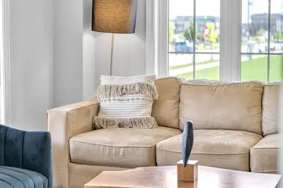 a brown couch in a living room with a table at Lavish Home on Hamilton Mountain in Hamilton