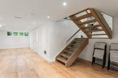 an empty living room with a staircase in a house at Luxury Home - 5 min from airport, 15 to downtown in Toronto