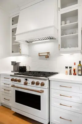a white kitchen with a stove and white cabinets at Luxury Home - 5 min from airport, 15 to downtown in Toronto
