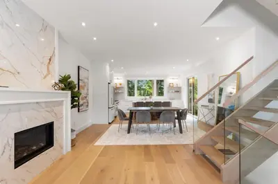 a dining room and living room with a table and a fireplace at Luxury Home - 5 min from airport, 15 to downtown in Toronto