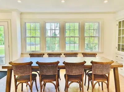 a large dining room with a large wooden table and chairs at Waterfront Niagara-On-The-Lake Farmhouse on a Vineyard in Niagara on the Lake