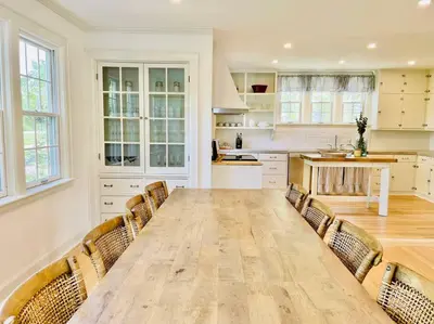 a large kitchen with a wooden table and chairs at Waterfront Niagara-On-The-Lake Farmhouse on a Vineyard in Niagara on the Lake