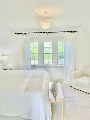 a white bedroom with a bed and a couch at Waterfront Niagara-On-The-Lake Farmhouse on a Vineyard in Niagara on the Lake