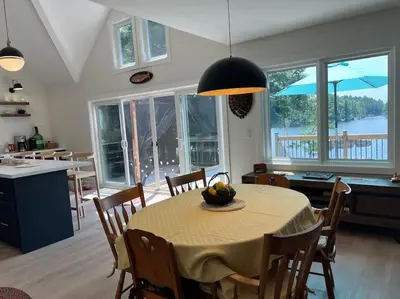 a kitchen and dining room with a table and chairs at Davi's Lake House in Torrance