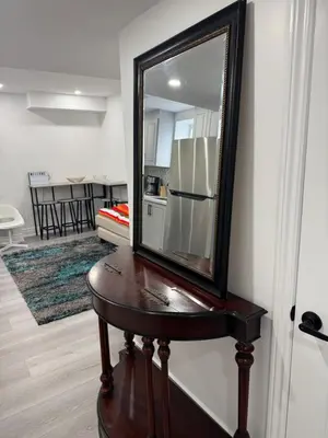 a mirror on a table next to a kitchen at New Furnished Basement Apartment Milton For Single, Couple or Small Family in Milton