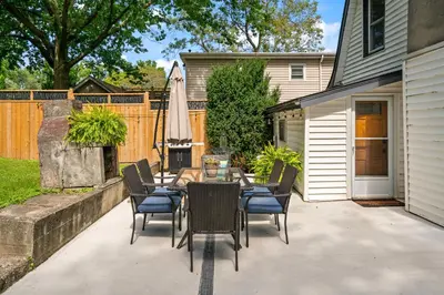 a patio with a table and chairs and an umbrella at Queenston Cottage in Queenston