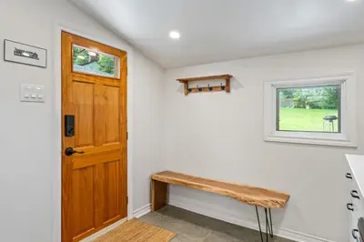 a room with a wooden door and a bench at Queenston Cottage in Queenston