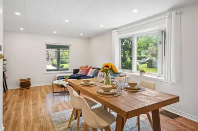a dining room with a wooden table and chairs at Queenston Cottage in Queenston