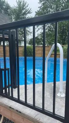 a pool with a pool gate with a swimming pooliteratorhaarhaarhaarhaarhaar at Sunset Suites in Niagara Wine Country in Niagara on the Lake
