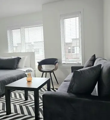 a living room with a couch and a table at SPRUCE Private Suite with attached Full Bathroom in Toronto, Canada in Toronto