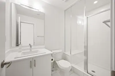a white bathroom with a toilet and a shower at SPRUCE Private Suite with attached Full Bathroom in Toronto, Canada in Toronto